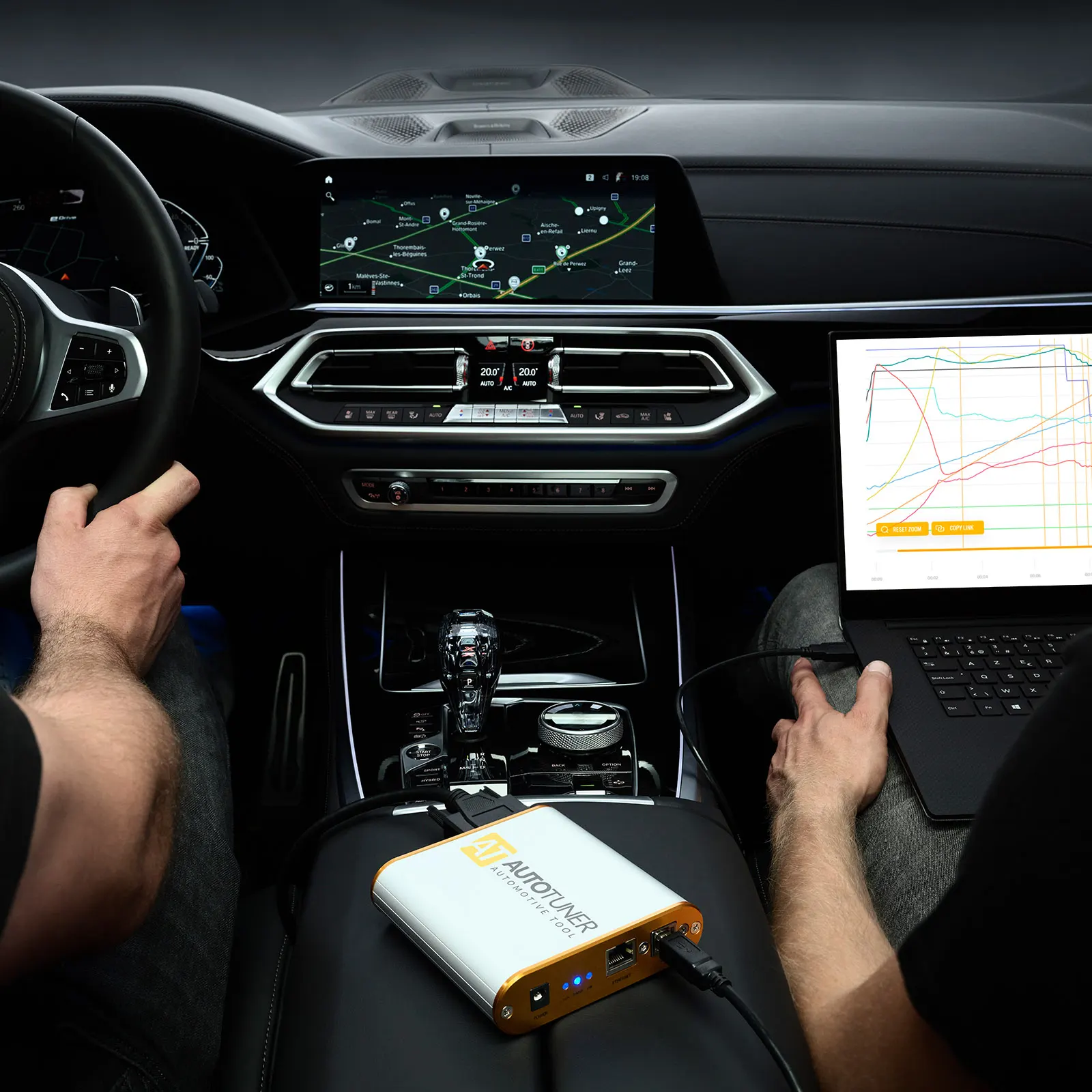 Technician using AutoTuner diagnostic tool inside BMW for professional automotive locksmith service